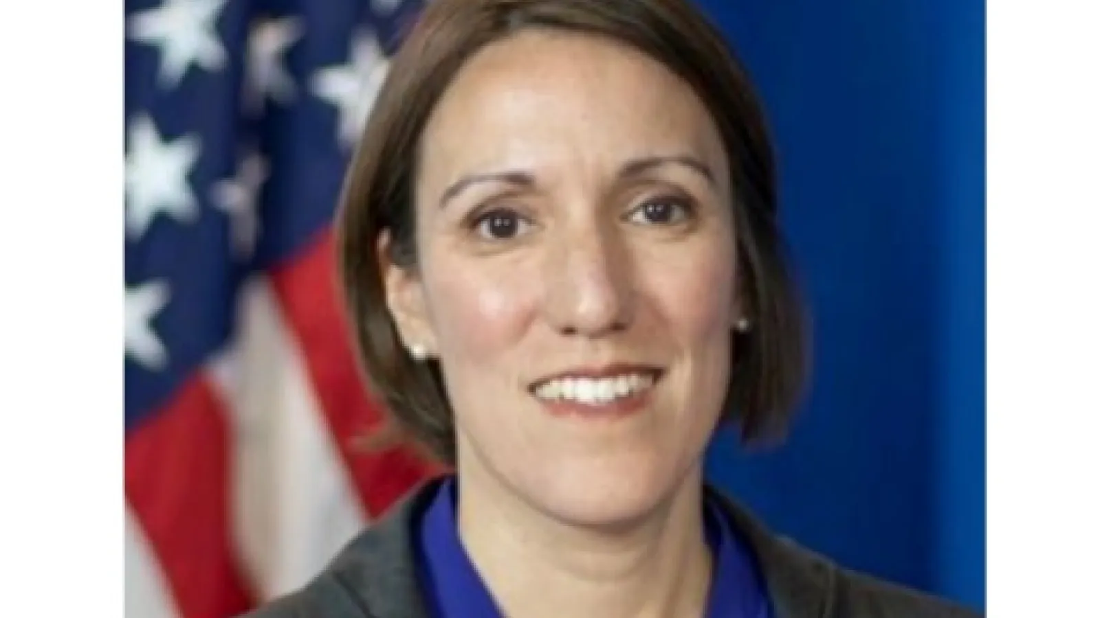 Alison's headshot with American flag in background