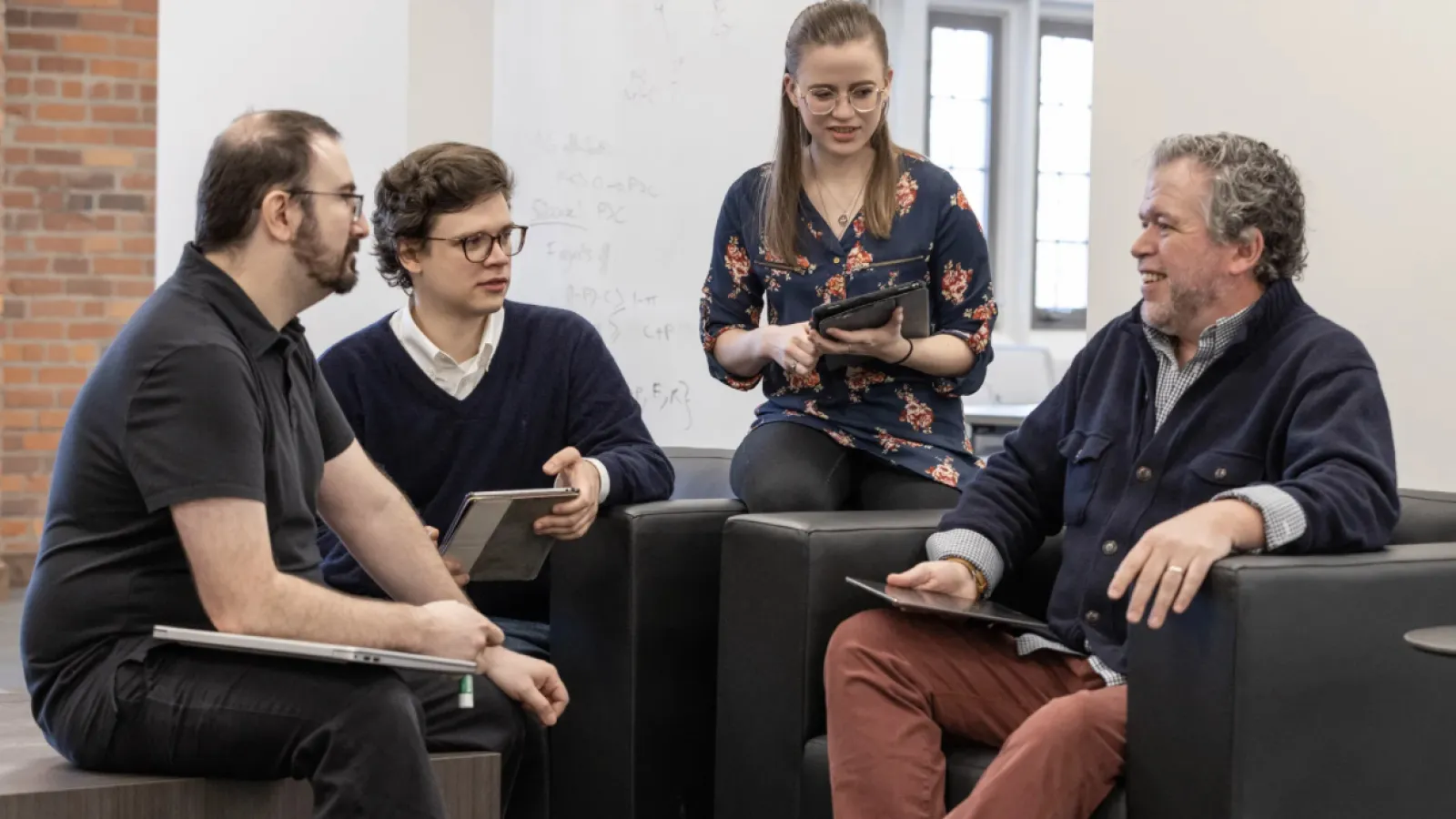 From left, political science graduate student Michael Lopate, Alan van Beek ’23 PhD and Caroline Barto ’22 meet with Professor Bear F. Braumoeller. (Photo by Jodi Miller)