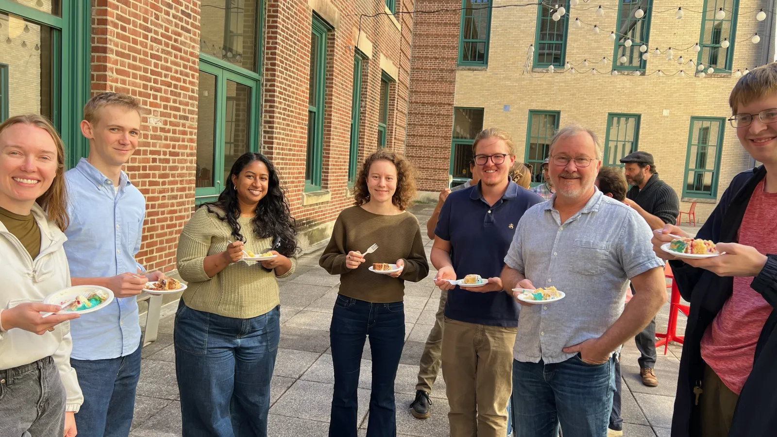 Faculty enjoying cake