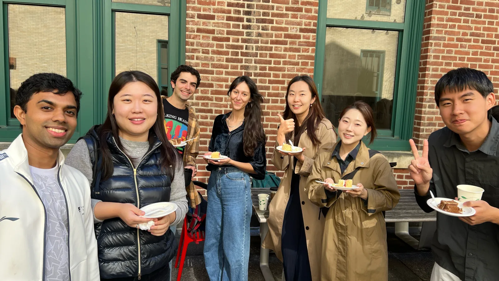 Students and faculty enjoying cake