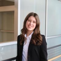 Riley Hoover headshot in a blazer and white shirt