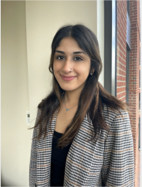 Noor Pasha headshot in a plaid blazer