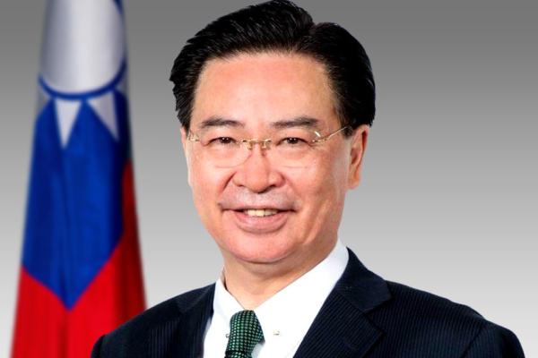 Joseph Wu Headshot in front of Taiwan flag