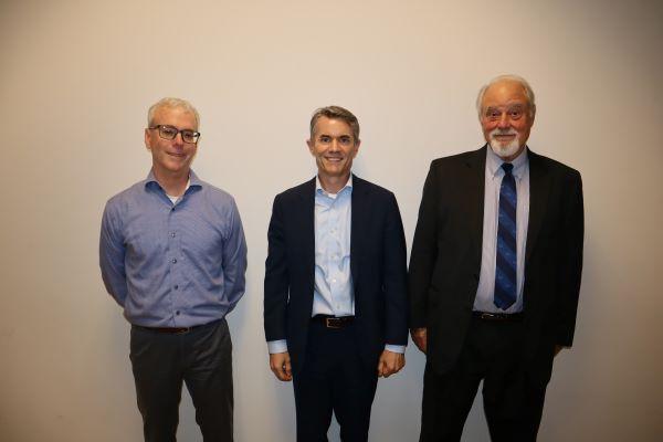 A picture of three board members standing by each other